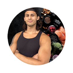 Man in a black tank top surrounded by fruits and vegetables on a white background